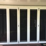 white framed bi-fold doors leading to the side of the home - bi-fold screen doors toowoomba