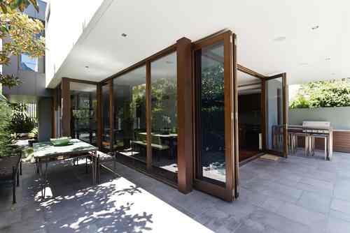 big bi fold doors opened with wooden finish near patio