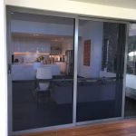 sliding door with steel coloured frames on a brown deck - sliding doors toowoomba
